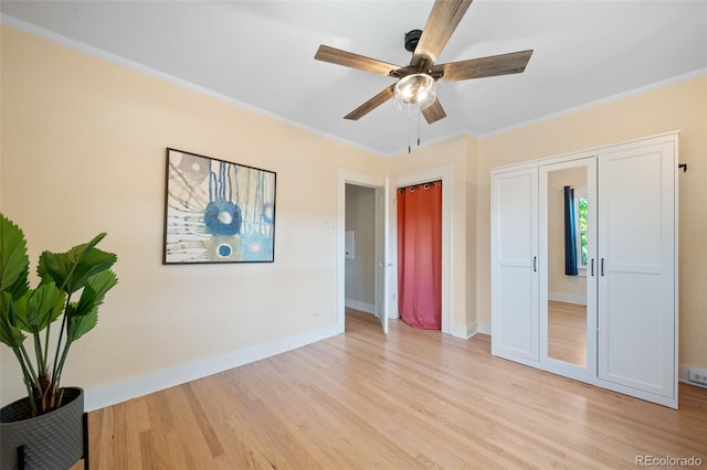 unfurnished bedroom with crown molding, ceiling fan, and light hardwood / wood-style floors