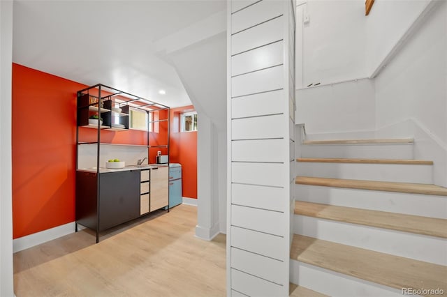 stairway with hardwood / wood-style flooring