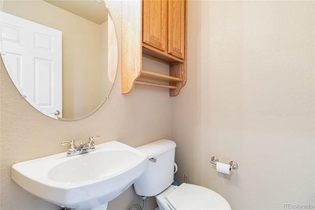 bathroom with toilet and sink