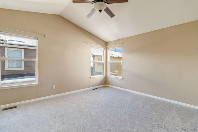 carpeted spare room with vaulted ceiling and ceiling fan