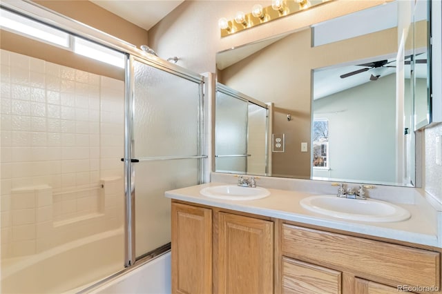 bathroom featuring shower / bath combination with glass door, ceiling fan, vanity, and vaulted ceiling