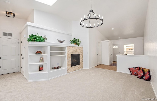 living room featuring light colored carpet, lofted ceiling, a notable chandelier, and a fireplace