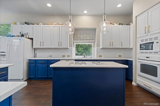 329 Bobcat Pt, Lafayette, CO 80026 - kitchen with blue cabinetry, white appliances, light countertops, a center island, and recessed lighting