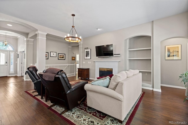 329 Bobcat Pt, Lafayette, CO 80026 - living room featuring dark wood-style floors, a fireplace, built in features, decorative columns, and recessed lighting
