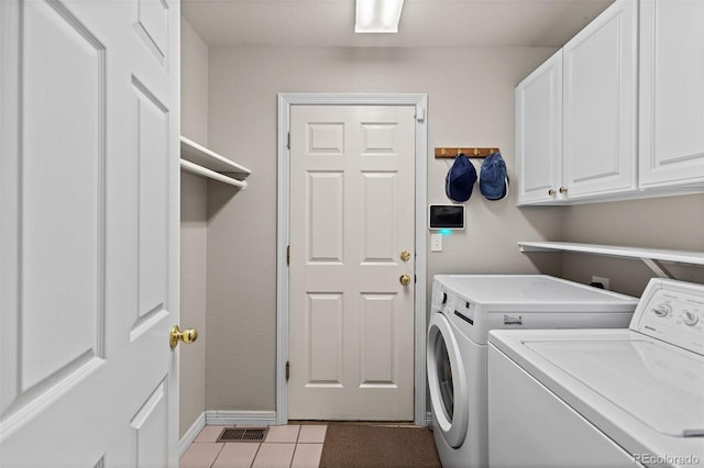 329 Bobcat Pt, Lafayette, CO 80026 - laundry room featuring washer and clothes dryer, cabinet space, and light tile patterned flooring