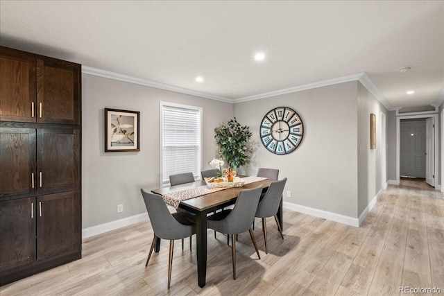 dining area with light hardwood / wood-style flooring and crown molding