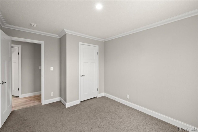 unfurnished bedroom featuring crown molding and carpet