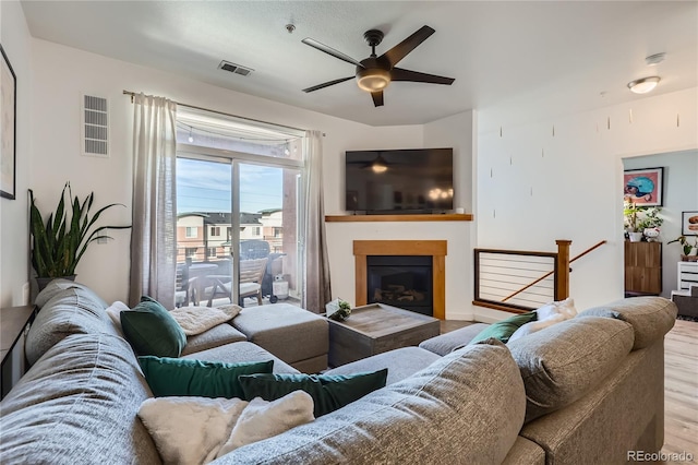 living room featuring ceiling fan and light wood-type flooring