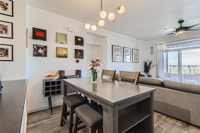 dining area featuring light hardwood / wood-style floors and ceiling fan