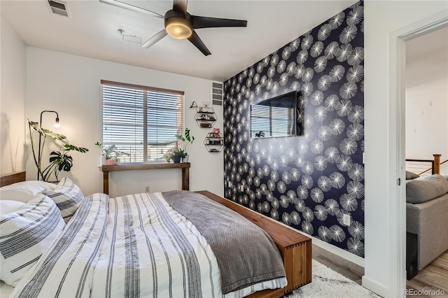 bedroom featuring light hardwood / wood-style floors and ceiling fan