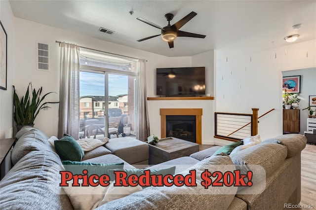 4100 Albion St Unit 221, Denver, CO 80216 - living room with wood finished floors, ceiling fan, and a glass covered fireplace