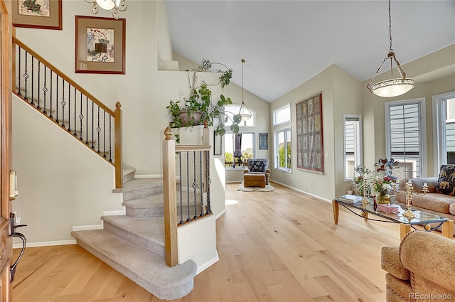 165 Washington St, Golden, CO 80403 - foyer with high vaulted ceiling, stairs, wood finished floors, and baseboards
