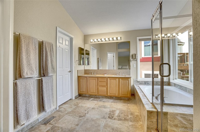 165 Washington St, Golden, CO 80403 - bathroom featuring a garden tub, double vanity, and stone finish flooring