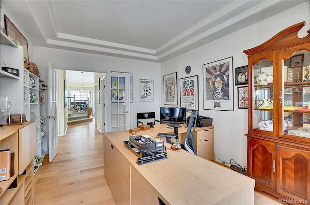 165 Washington St, Golden, CO 80403 - home office with a tray ceiling, light wood-style floors, and a chandelier
