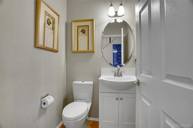165 Washington St, Golden, CO 80403 - half bath featuring vanity, toilet, and a textured wall