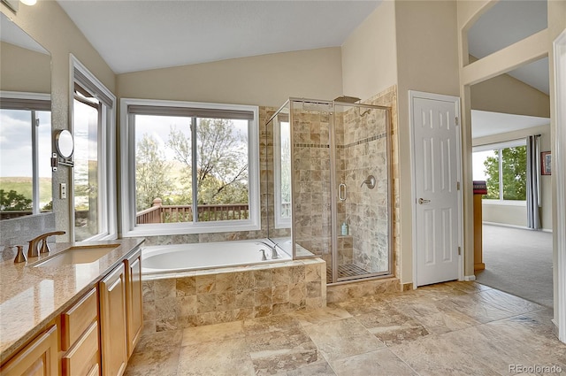 165 Washington St, Golden, CO 80403 - full bath featuring vaulted ceiling, vanity, a bath, a stall shower, and stone tile flooring