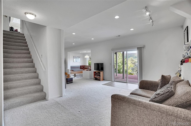 165 Washington St, Golden, CO 80403 - carpeted living room with stairs, rail lighting, recessed lighting, and baseboards
