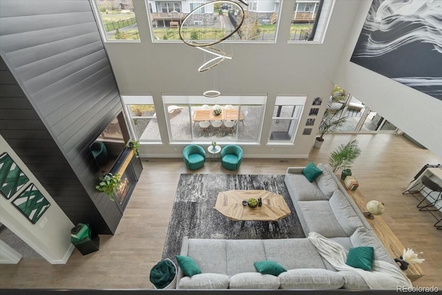 27250 E Nova Cir, Aurora, CO 80016 - living room featuring healthy amount of natural light, wood finished floors, and a towering ceiling