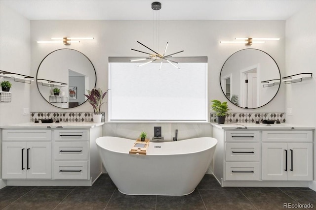 27250 E Nova Cir, Aurora, CO 80016 - bathroom with plenty of natural light, tile patterned flooring, a chandelier, and a freestanding tub