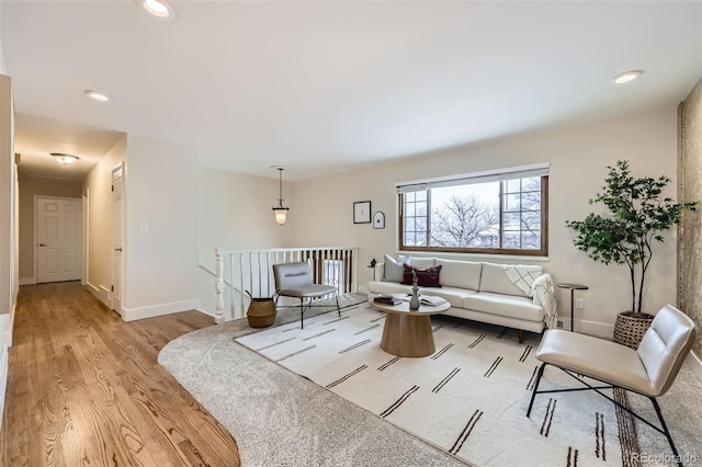 living area with light wood-style floors, recessed lighting, and baseboards