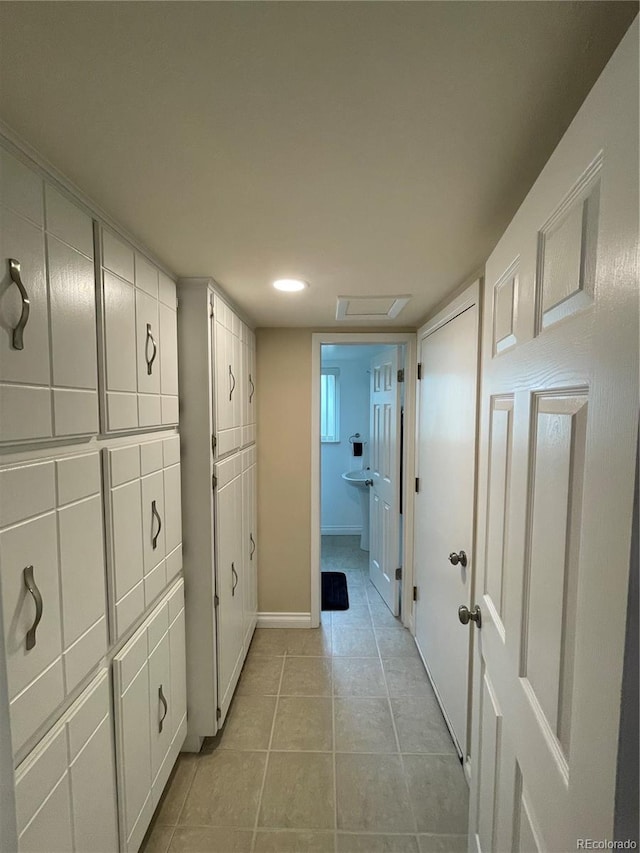 hall with light tile patterned floors