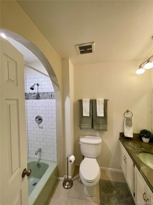 full bathroom with tiled shower / bath combo, vanity, toilet, and tile patterned floors