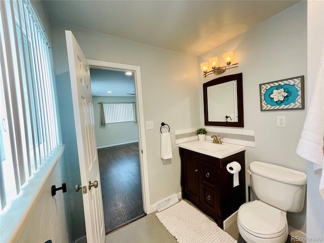 bathroom featuring vanity, toilet, and hardwood / wood-style flooring