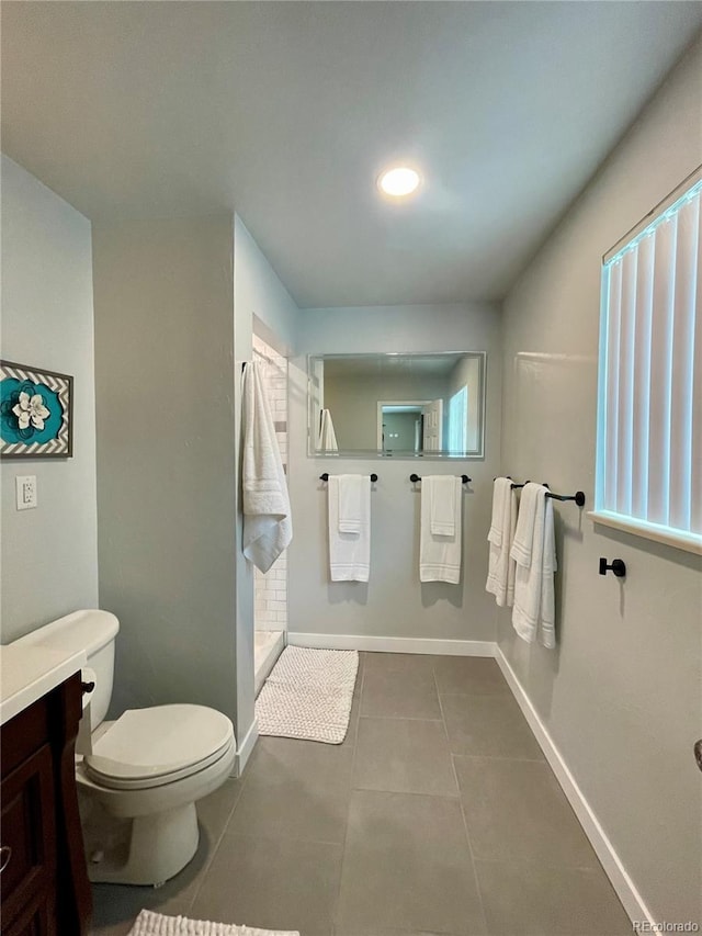 bathroom with tile patterned flooring, vanity, and toilet