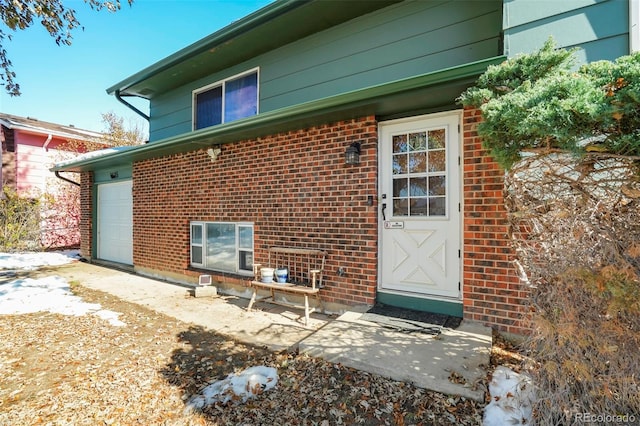 view of exterior entry with a garage