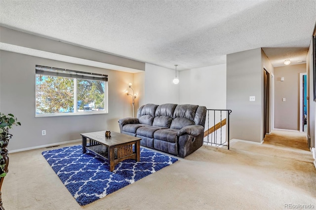 carpeted living room with a textured ceiling