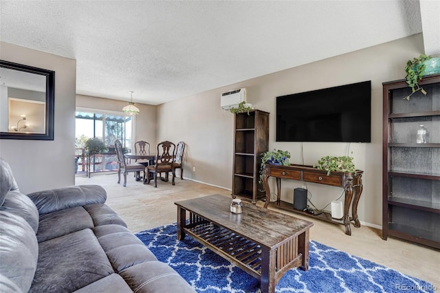 carpeted living room featuring a wall mounted air conditioner and a textured ceiling