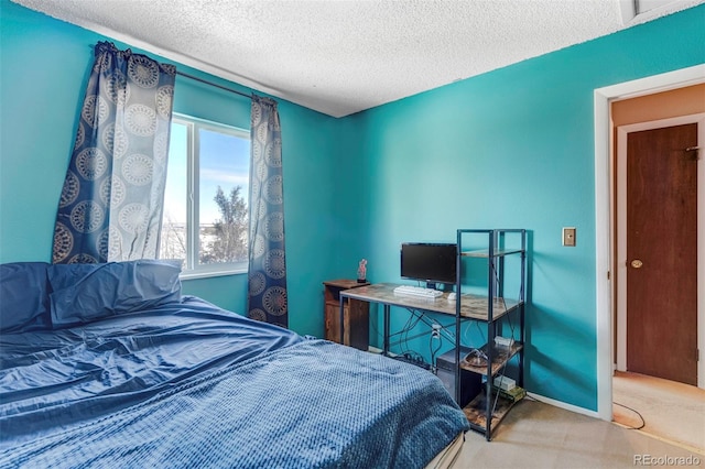 carpeted bedroom featuring a textured ceiling