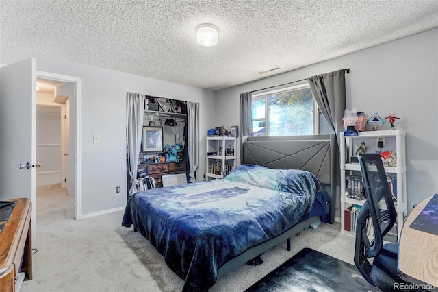 carpeted bedroom featuring a textured ceiling