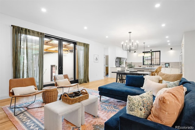 659 Albion St, Denver, CO 80220 - living room with a chandelier, recessed lighting, and light wood-style floors