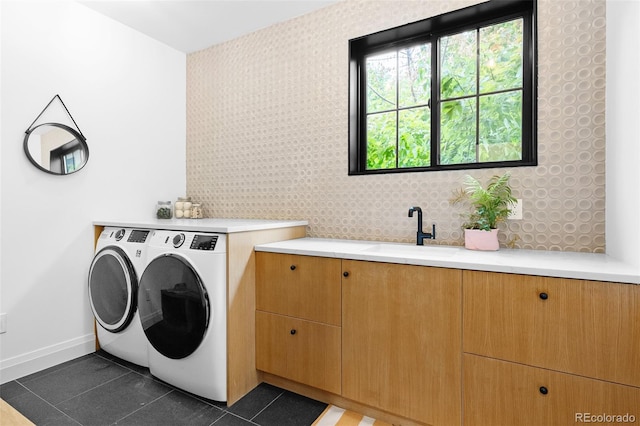 659 Albion St, Denver, CO 80220 - washroom featuring separate washer and dryer, baseboards, cabinet space, and dark tile patterned flooring