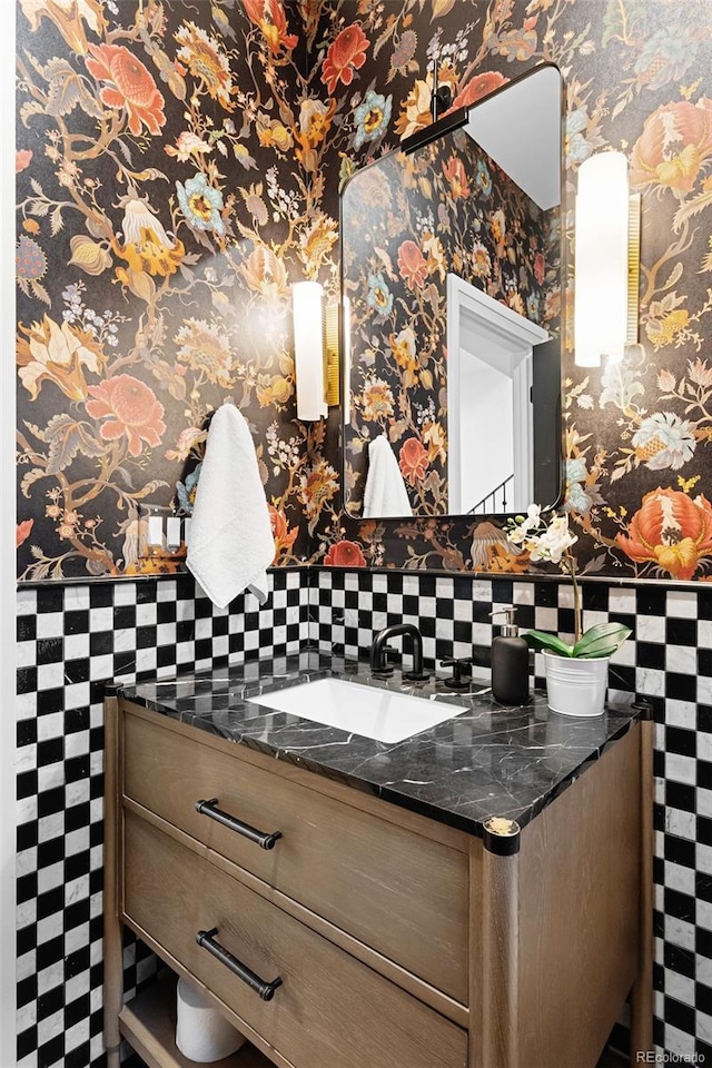 659 Albion St, Denver, CO 80220 - bathroom featuring tile walls, vanity, and wallpapered walls