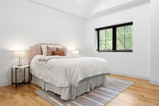 659 Albion St, Denver, CO 80220 - bedroom featuring wood finished floors, baseboards, and lofted ceiling