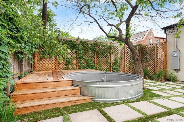 659 Albion St, Denver, CO 80220 - fenced yard with a hot tub and a wooden deck