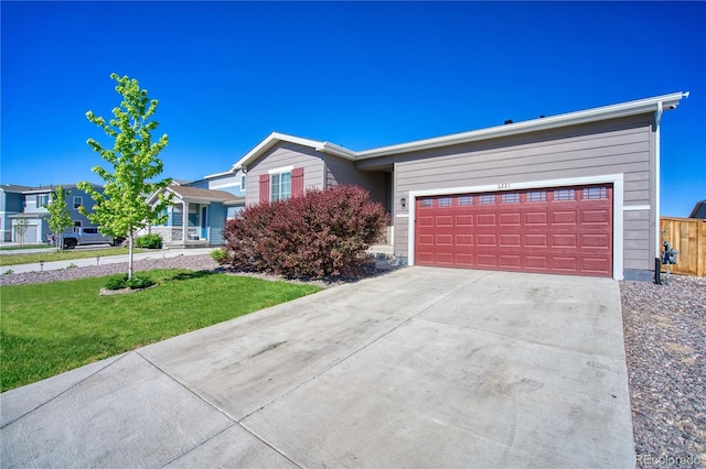 single story home with driveway, a garage, and a front yard