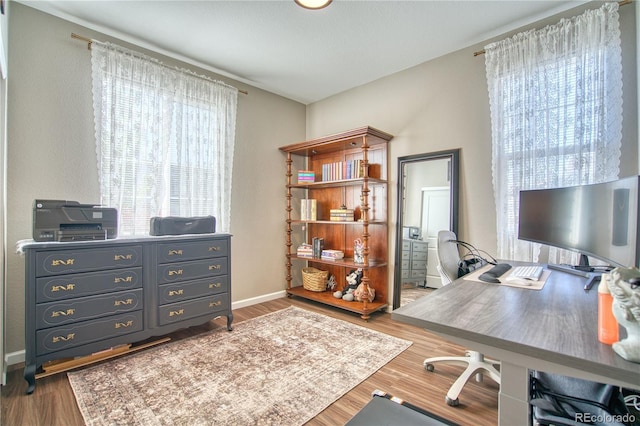 home office featuring wood finished floors and baseboards