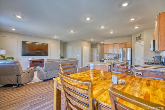 dining area featuring recessed lighting and wood finished floors