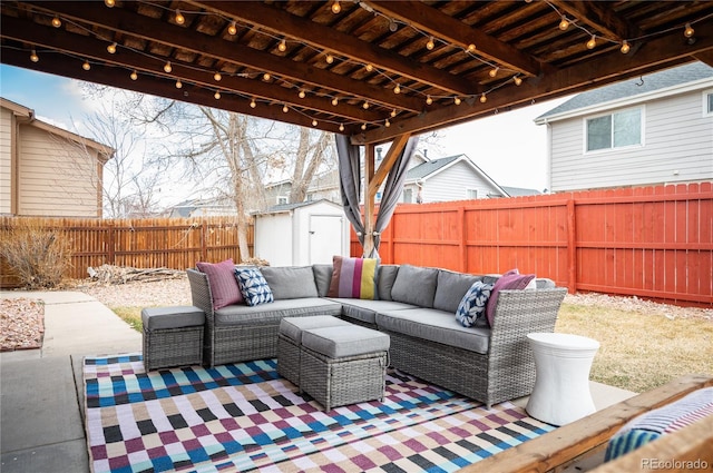 view of patio featuring a fenced backyard, an outdoor structure, an outdoor living space, and a shed