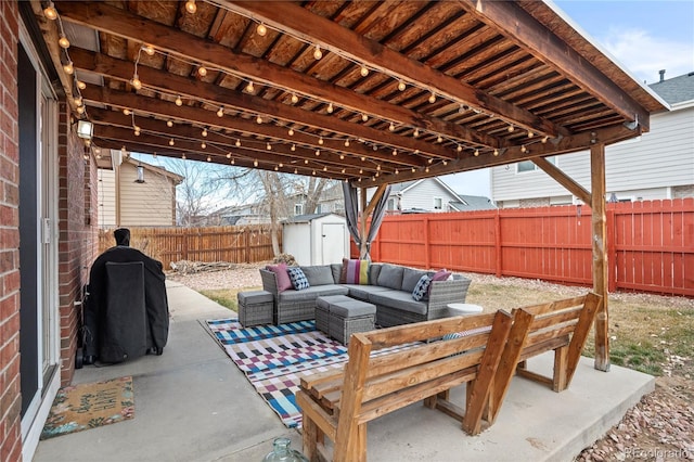 view of patio featuring a fenced backyard, an outdoor hangout area, an outdoor structure, area for grilling, and a storage unit