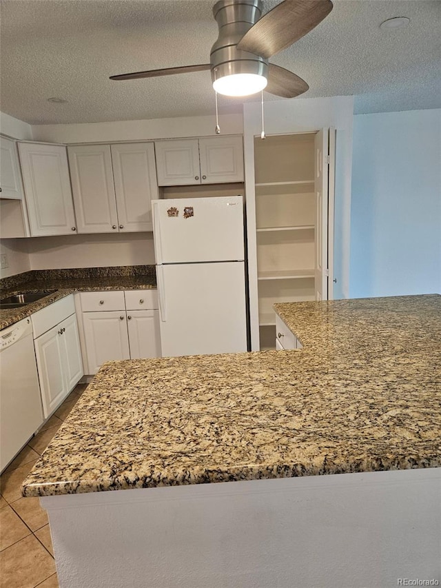 1304 S Parker Rd Unit 13, Denver, CO 80231 - kitchen with white appliances, a ceiling fan, a textured ceiling, white cabinets, and a sink