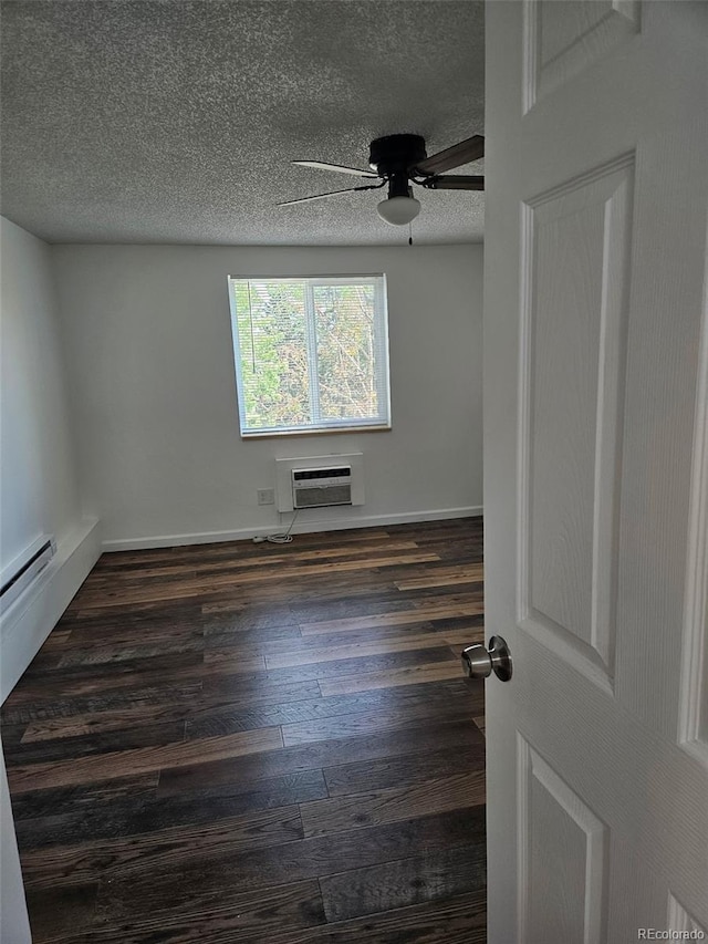 1304 S Parker Rd Unit 13, Denver, CO 80231 - empty room featuring a wall mounted AC, a ceiling fan, a textured ceiling, dark wood-type flooring, and baseboards