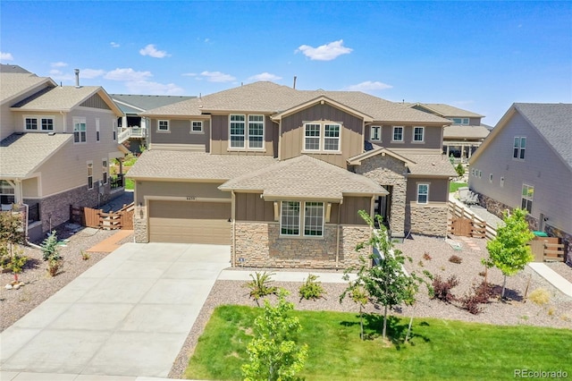 6639 S Vandriver Way, Aurora, CO 80016 - view of front of home featuring board and batten siding, stone siding, a garage, roof with shingles, and driveway