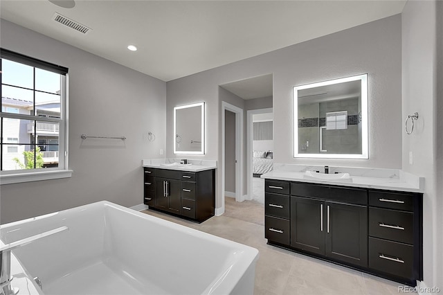 6639 S Vandriver Way, Aurora, CO 80016 - full bath with a soaking tub, two vanities, tile patterned flooring, and tiled shower