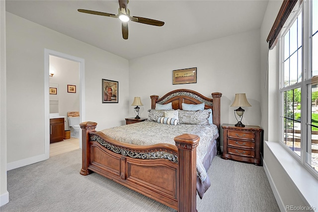 6639 S Vandriver Way, Aurora, CO 80016 - bedroom featuring light carpet, multiple windows, ensuite bath, and ceiling fan