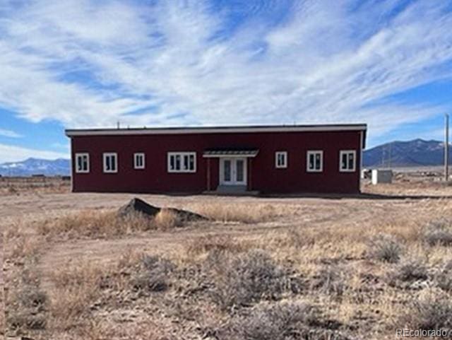 back of house with a mountain view and french doors