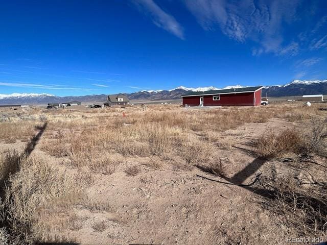 view of yard featuring a mountain view and a rural view